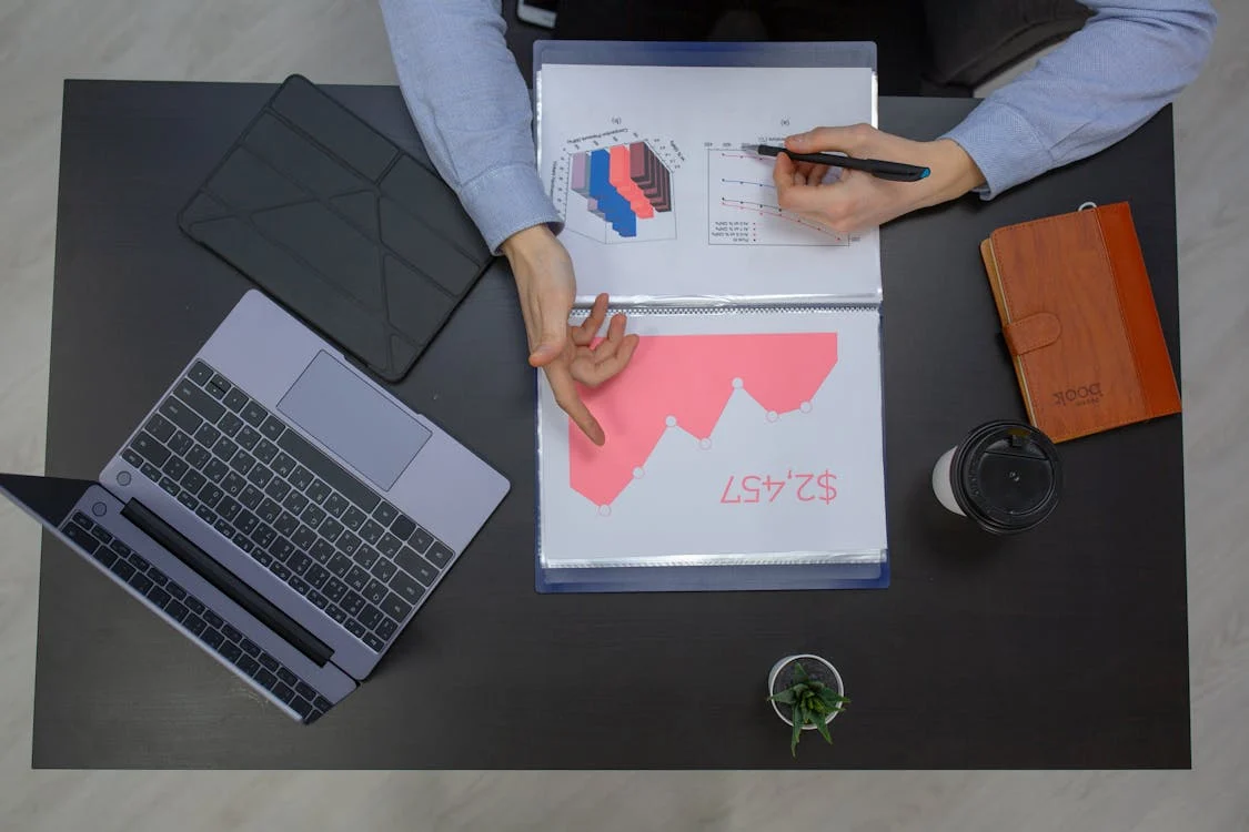 A private investigator analyzing documents and reports at a desk