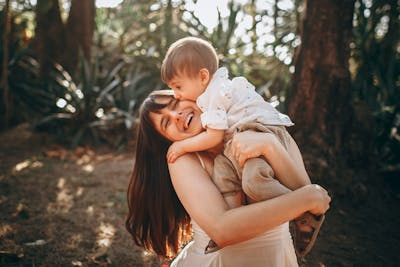 A parent playing with their child in a park