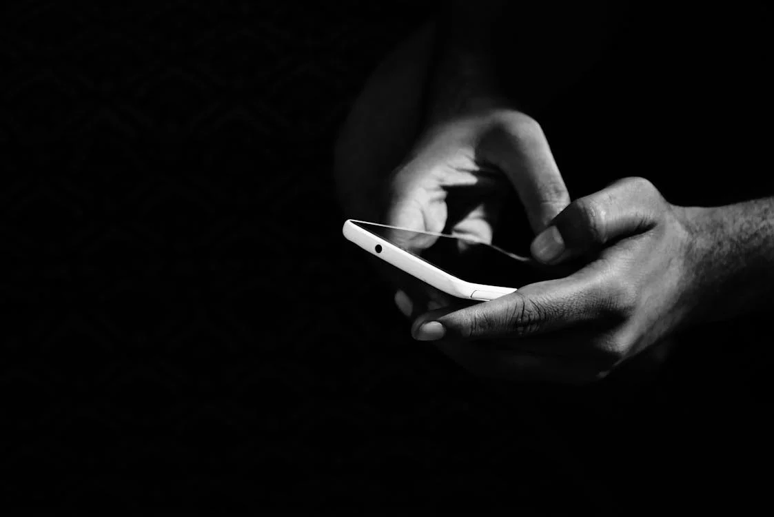 Private investigator conducting surveillance using a smartphone