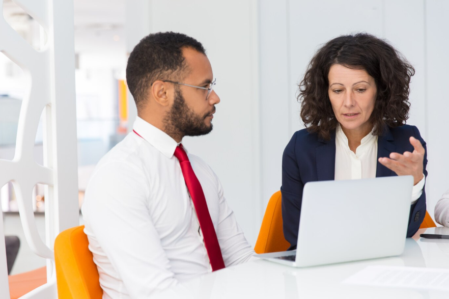 an employee and boss discussing a serious matter