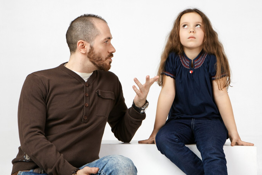 a man having serious conversation with his child