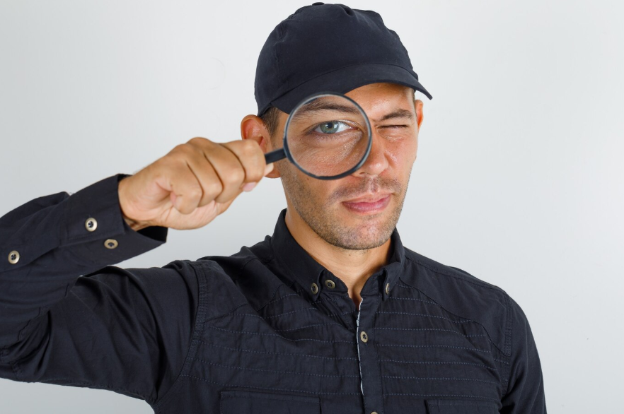 an investigator looking through magnifying glass