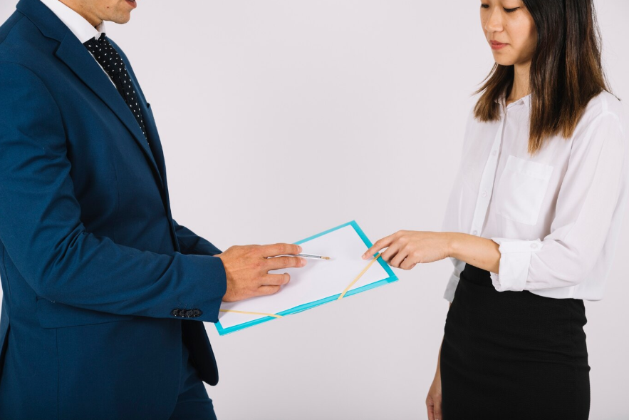 business people looking at clipboard