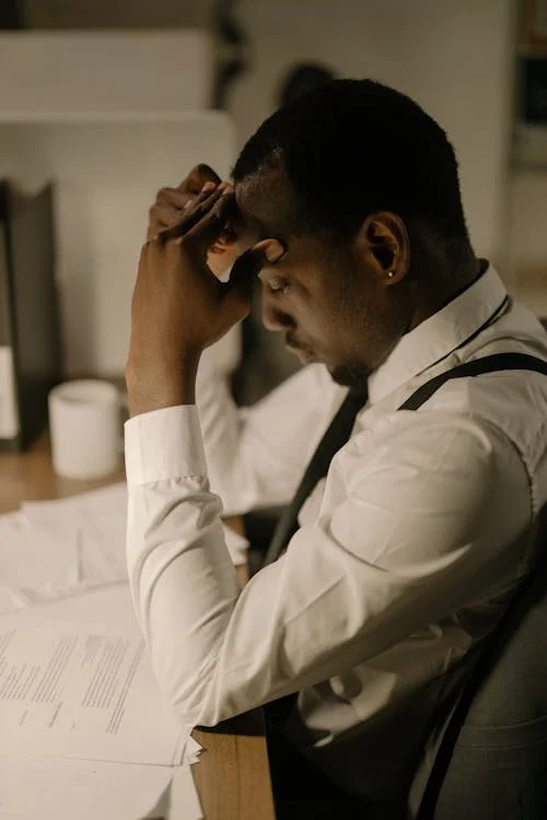 A private investigator analyzing case files and documents on a desk